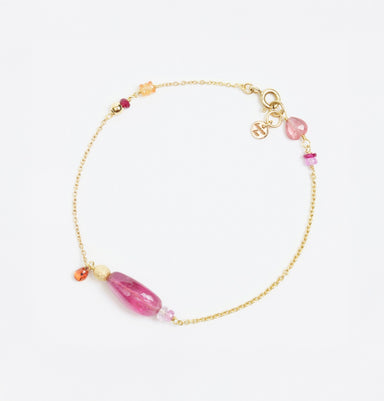 Gold bracelet featuring smooth pink tourmaline, orange and pink sapphires, and gold disco ball accents.