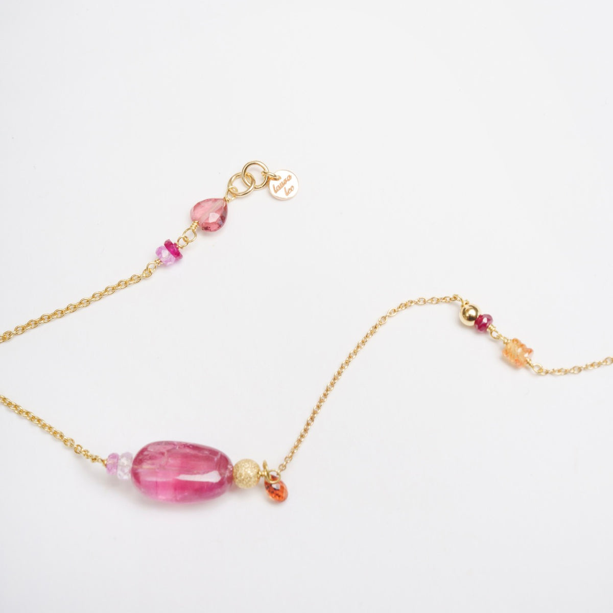 Bronzewing Bracelet 3 features an 18ct yellow gold chain with smooth pink tourmaline and colorful gemstone accents.