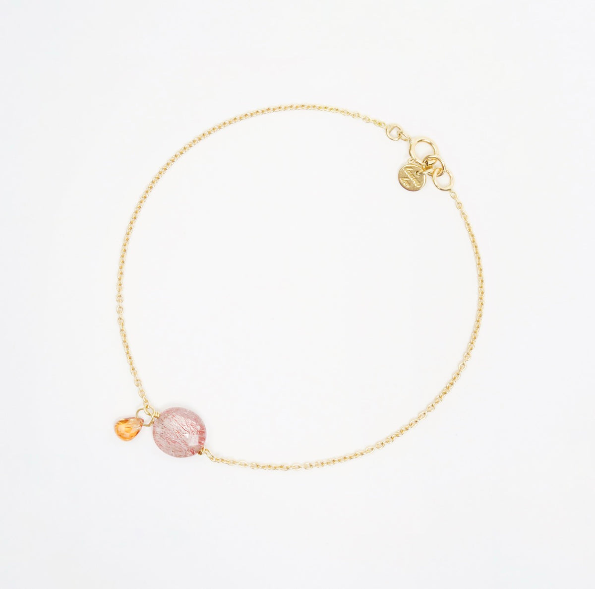 Strawberry Quartz Coin bracelet in 18ct yellow gold, features an orange sapphire drop for added charm.