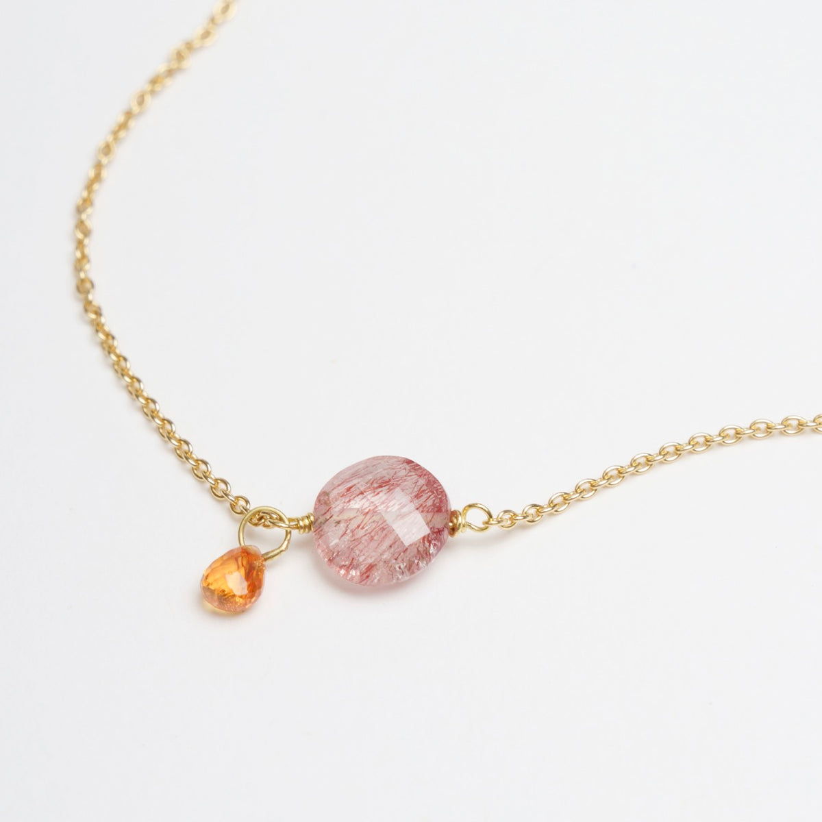 Strawberry Quartz Coin bracelet in 18ct yellow gold, featuring an orange sapphire drop charm.