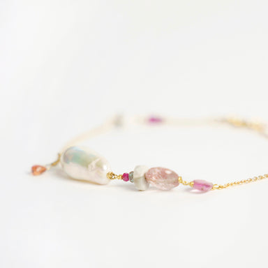 Bronzewing Bracelet 1 features a mix of gemstones, including a baroque pearl, orange sapphire, and pink sapphire, on a gold chain.