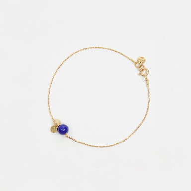 Delicate 18ct yellow gold chain bracelet featuring a rich lapis lazuli stone, gold sparkle bead, and textured gold sequin.