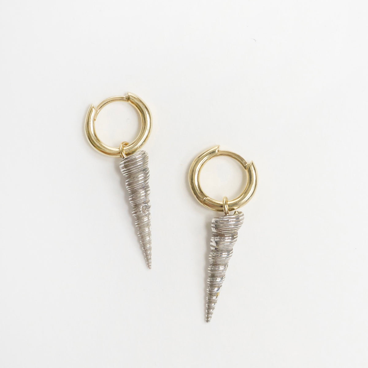 Sterling silver and 9ct yellow gold earrings featuring shell-shaped drops with a sleek, spiraled design.