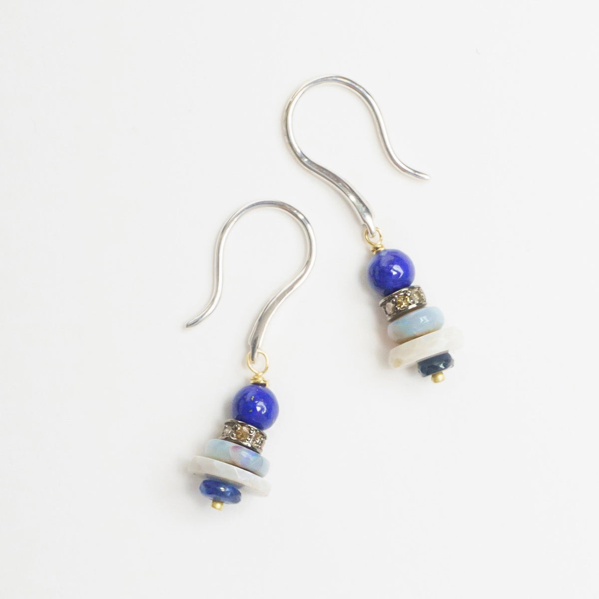 Mini stack earrings featuring blue lapis lazuli, grey opal, blue sapphire, and diamond rondelle beads.
