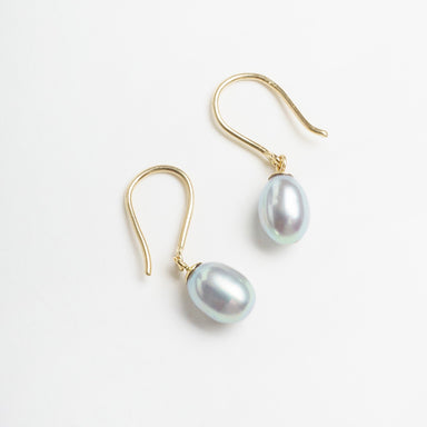 Silvery lavender egg-shaped pearls dangle from 9ct yellow gold hooks, showcasing a lustrous finish.