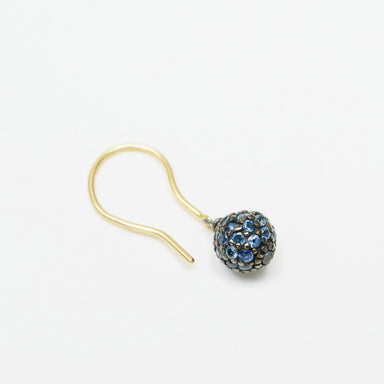 Sapphire Stardust Drop Earrings feature a round blackened silver bead adorned with blue sapphires, complemented by an 18ct yellow gold hook.