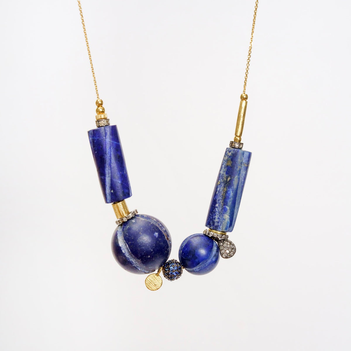 Unique Hippy Trail Necklace showcasing vintage lapis lazuli beads, accented with gold sequins and diamonds on a gold chain.