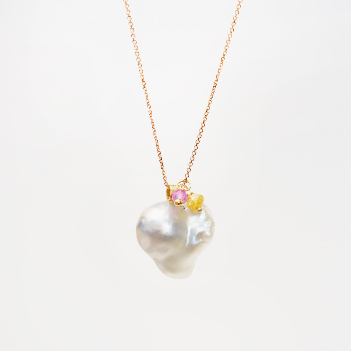 Heart-shaped South Sea pearl pendant on an 18ct rose gold chain, accented with yellow diamond and pink tourmaline details.