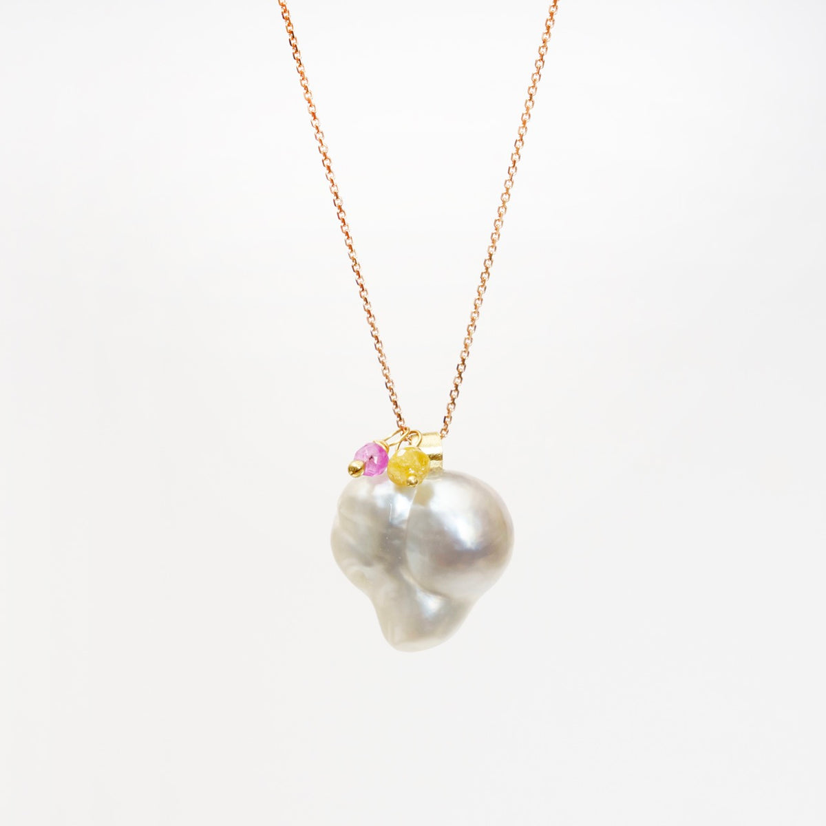 Heart-shaped South Sea pearl pendant on an 18ct rose gold chain, accented with pink tourmaline and canary yellow diamond.