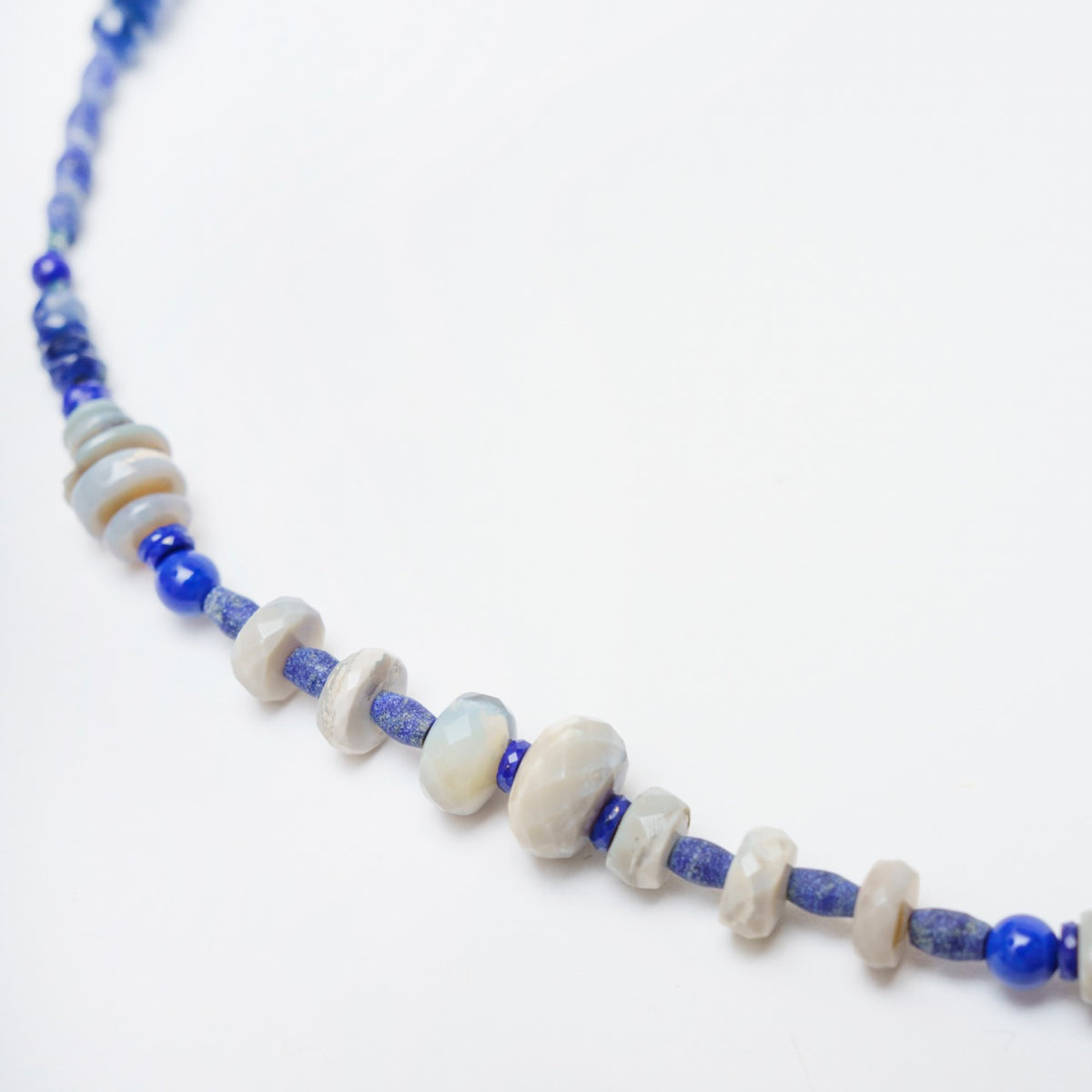 Hand-knotted choker featuring a mix of unpolished and polished lapis lazuli, grey opals, and blue sapphire beads.
