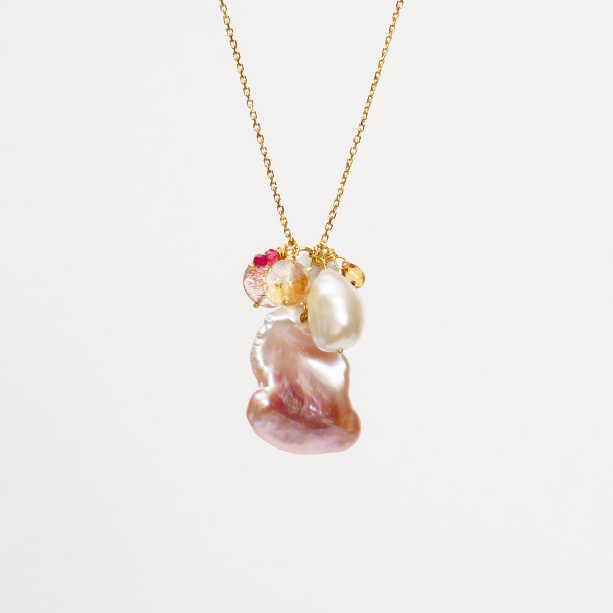 Baroque pink pearl cluster necklace featuring 18ct yellow gold chain, large pink pearl, and mixed colorful gems.