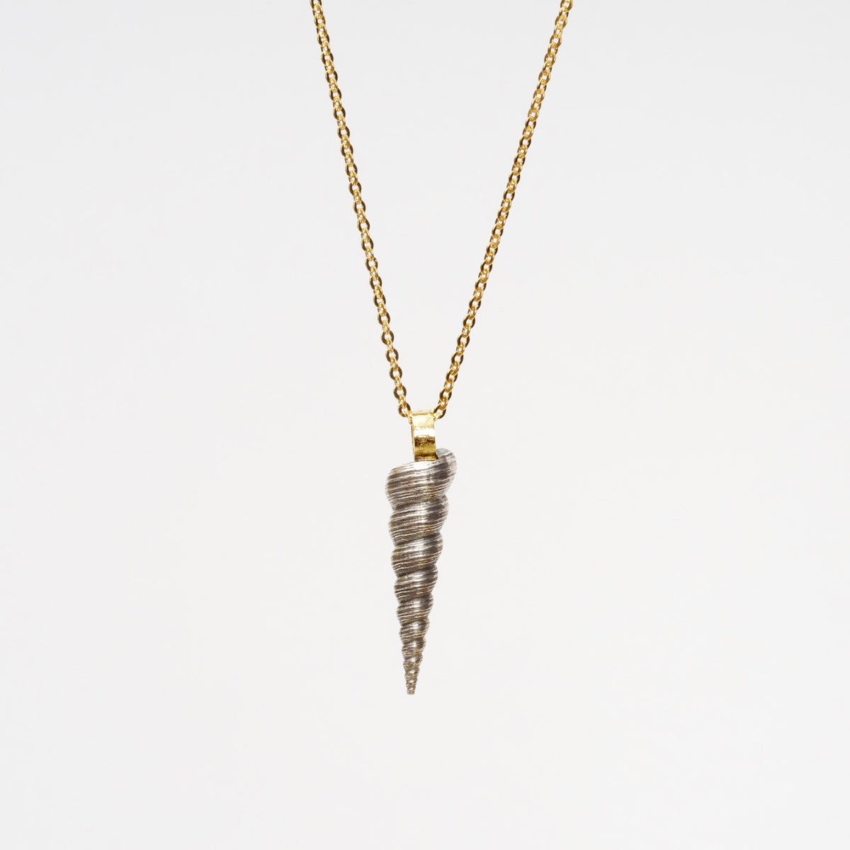 Sterling silver sculptural shell pendant with a handmade 18ct gold bail on a 25" yellow gold chain.