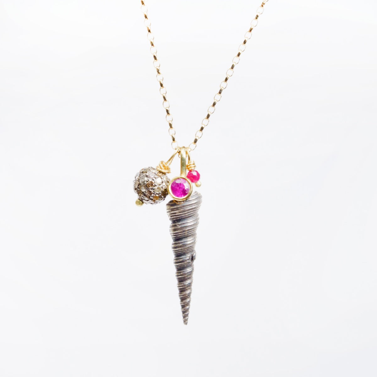 Silver shell pendant necklace with ruby cluster and champagne diamonds, hung on an 18ct yellow gold sparkle chain.