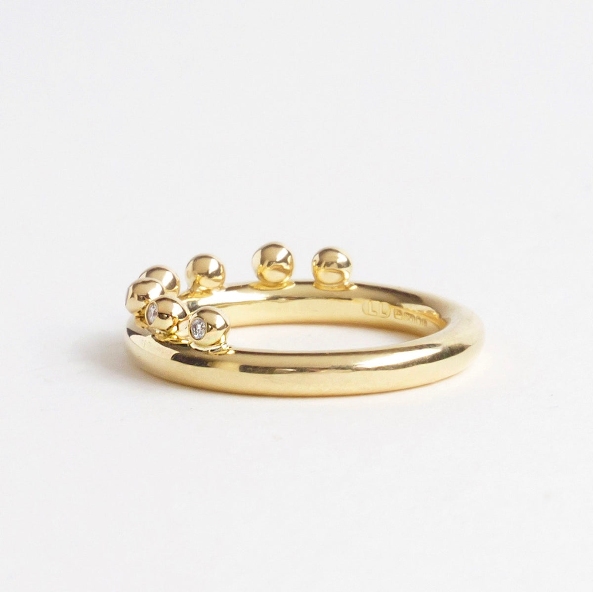 18ct yellow gold ring featuring seven bubble-like clusters and three sparkling diamonds in a smooth band design.